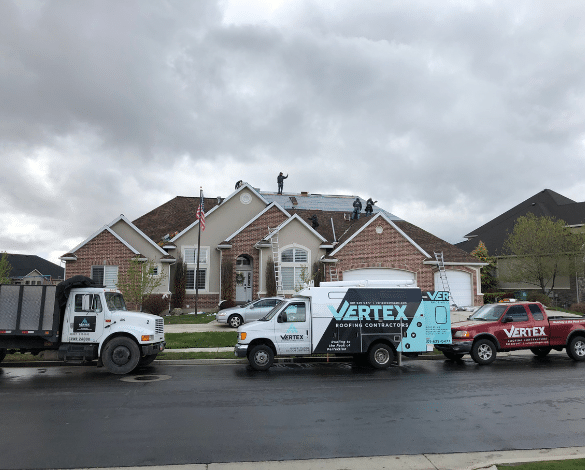 Vertex Roofing trucks at a Utah storm restoration project